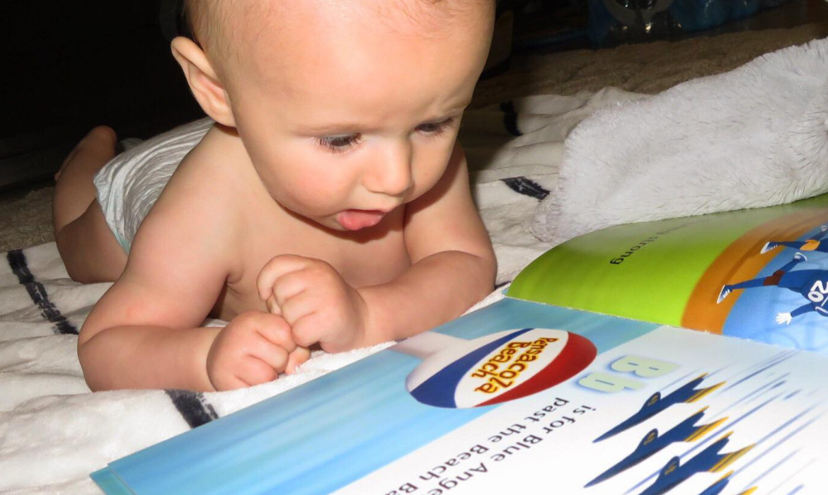 Baby looking at book