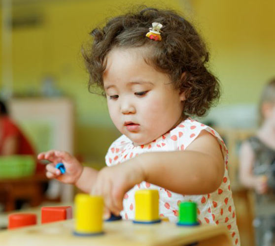 Toddler learn valuable skills through play and interaction with parents and siblings