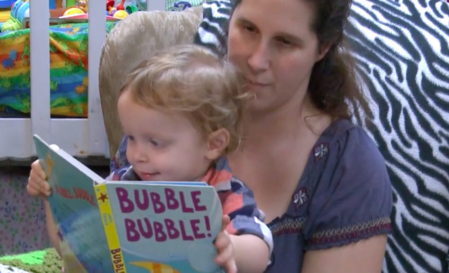 Woman reading the book Bubble Bubble to toddler