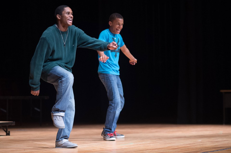 Two black teenagers dancing on stage