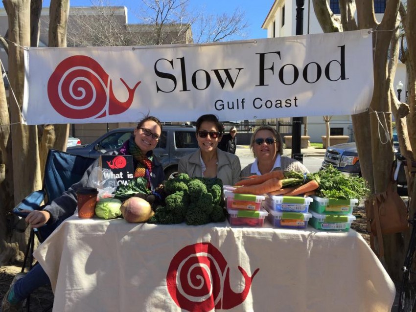 {{business_name}}Slow Food Gulf Coast representatives at the Palafox Market. 