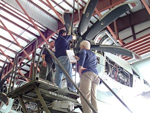 {{business_name}}Workers put a new NP2000 eight-blade propeller on a C-130 as part of the Electronic Propeller Control System (EPCS) upgrade. The propeller replaces the four-blade system for much better performance.