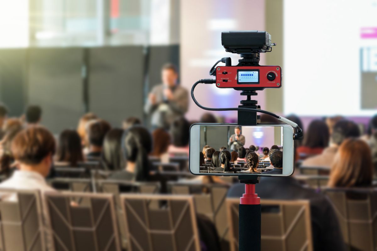 mobile phone on tripod videoing a speaker at a workshop